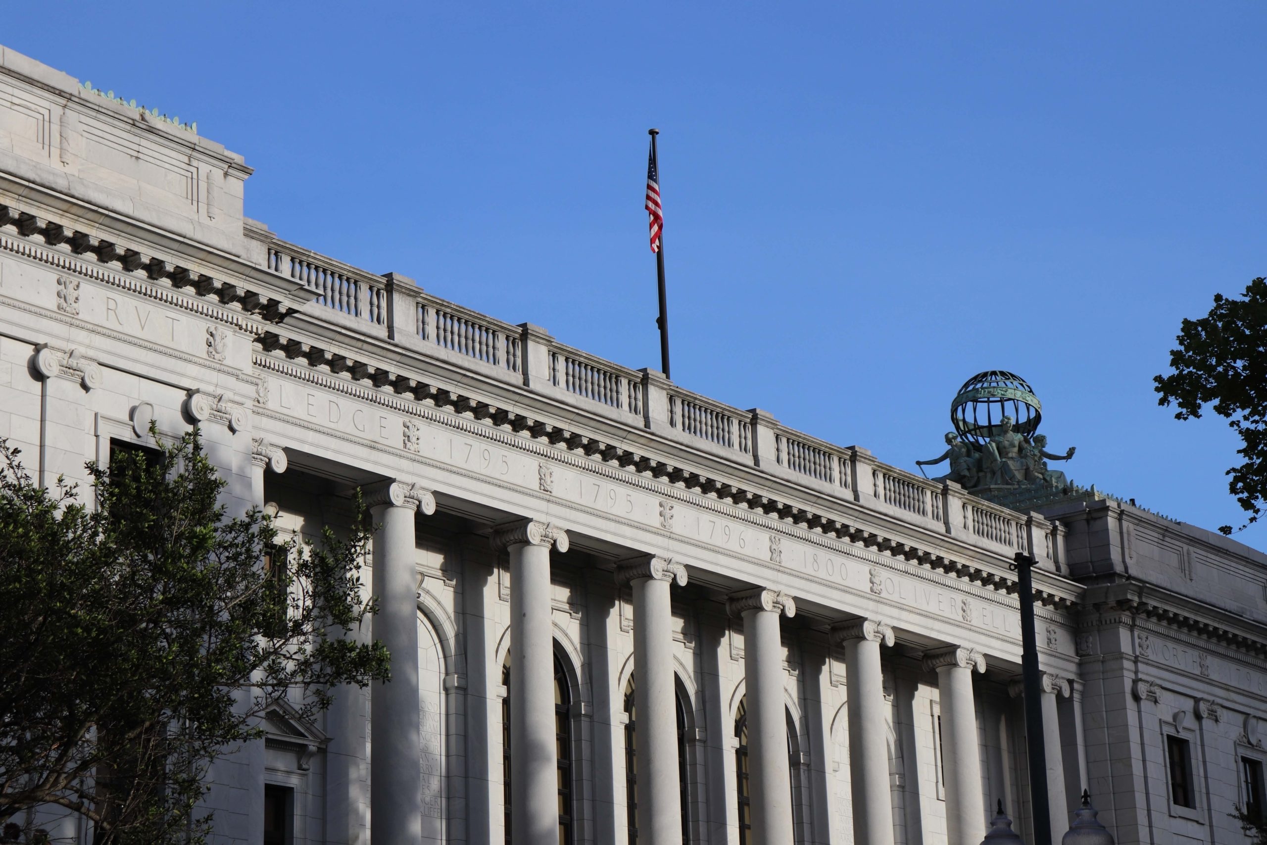 The side of a court building with U.S. flag overhead
