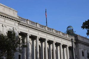 The side of a court building with U.S. flag overhead
