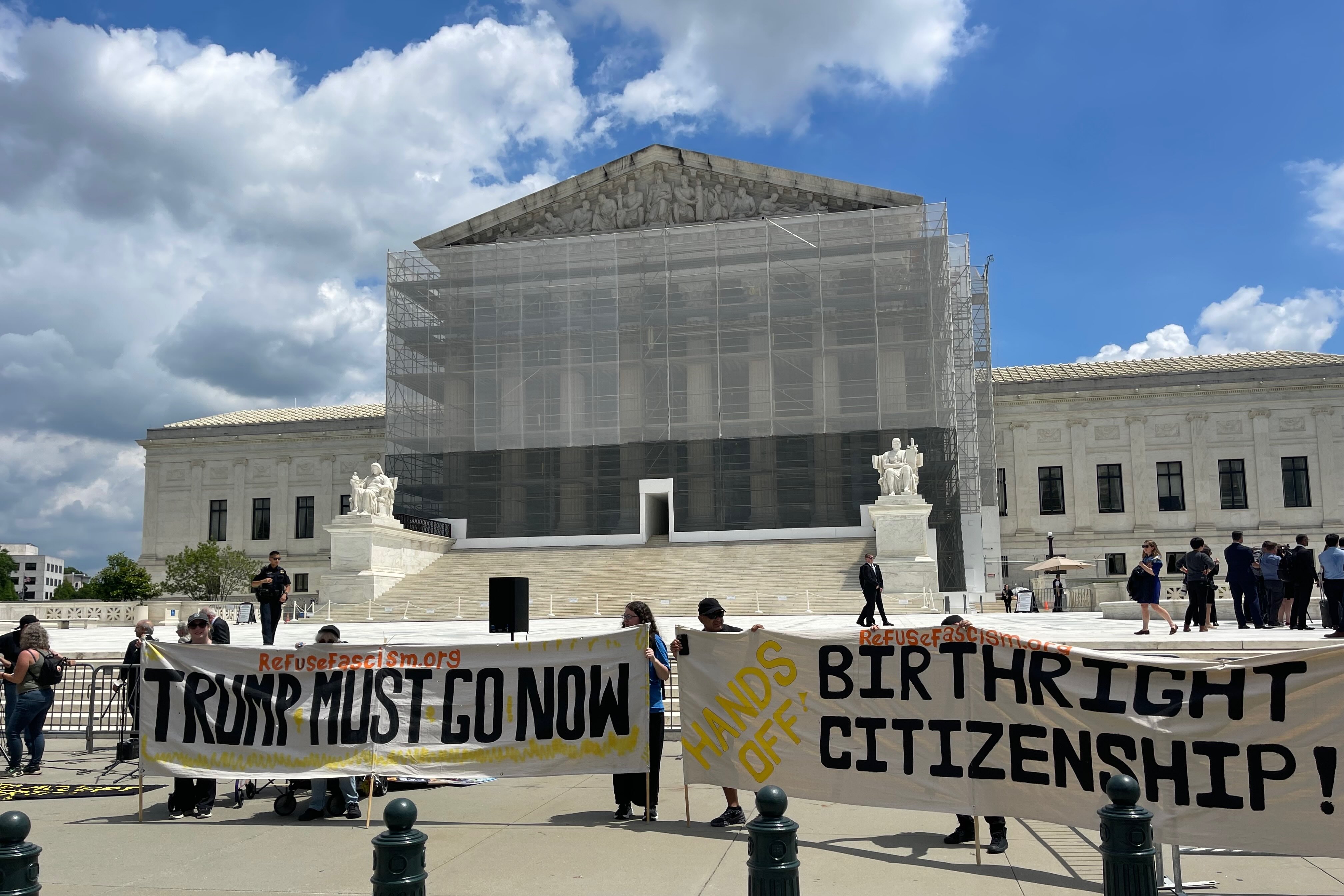 Protesters holding up anti-Trump banners in front of the Supreme Court