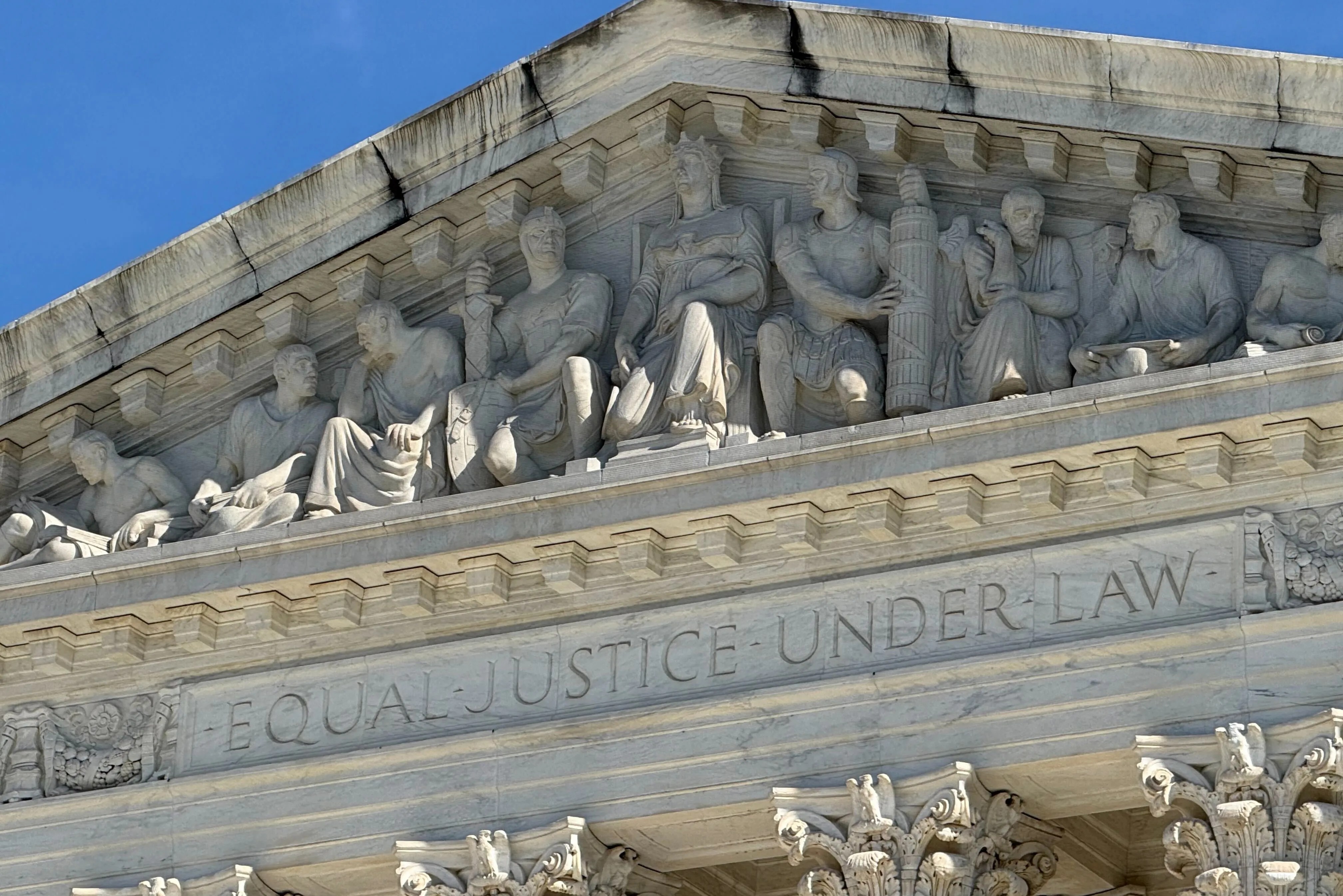 Carvings are shown at the top of the Supreme Court building