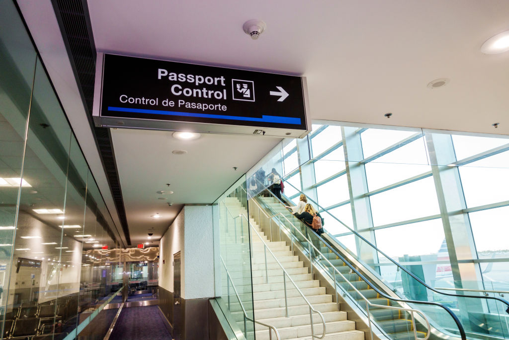 Florida, Miami International Airport bilingual passport control sign.